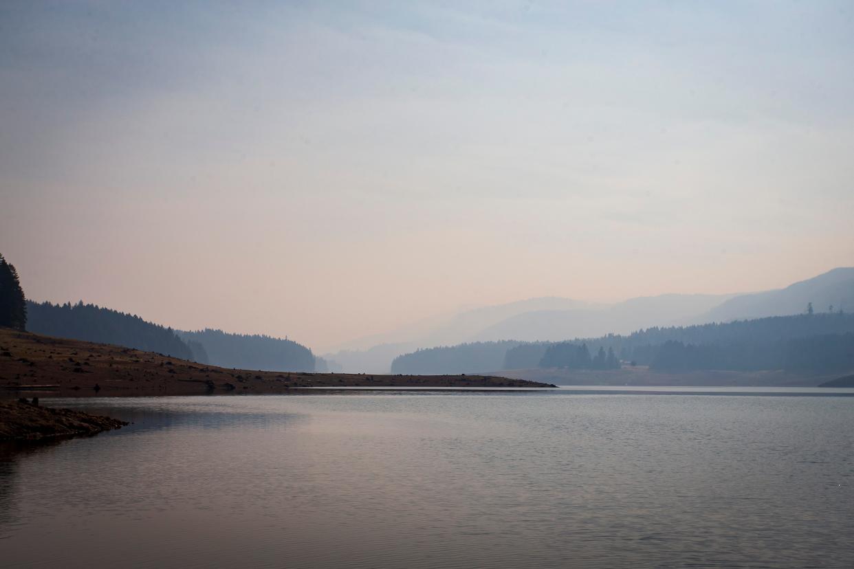 Smoke from the Bedrock Fire hangs over Fall Creek Lake on Tuesday.