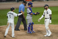 Chicago White Sox's Yoan Moncada, right, is congratulated by Nick Madrigal after hitting a two-run home run during the sixth inning of the team's baseball game against the Chicago Cubs in Chicago, Saturday, Sept. 26, 2020. (AP Photo/Nam Y. Huh)