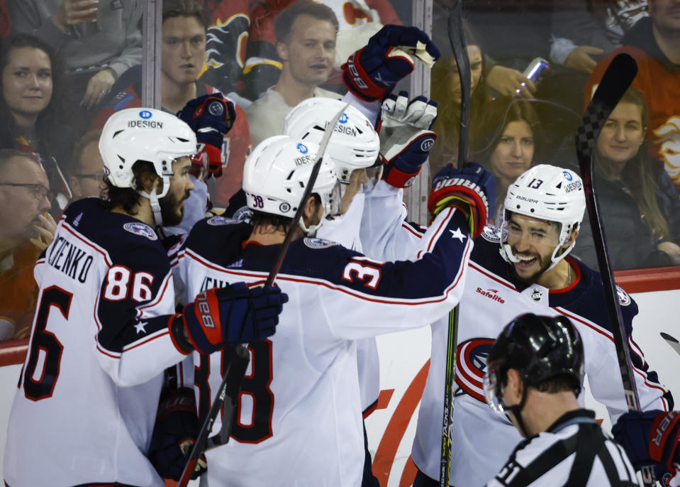 Columbus Blue Jackets forward Johnny Gaudreau, right, celebrates a goal with teammates during second-period NHL hockey game action against the Calgary Flames in Calgary, Alberta, Monday, Jan. 23, 2023. (Jeff McIntosh/The Canadian Press via AP)