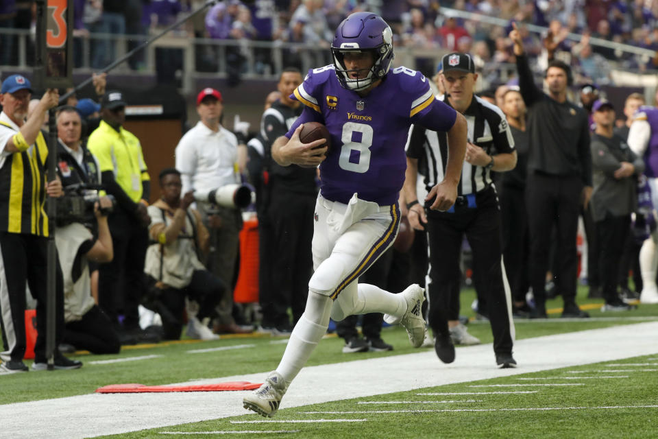 Minnesota Vikings quarterback Kirk Cousins (8) runs up field during a 17-yard touchdown run in the first half of an NFL football game against the Arizona Cardinals, Sunday, Oct. 30, 2022, in Minneapolis. (AP Photo/Bruce Kluckhohn)