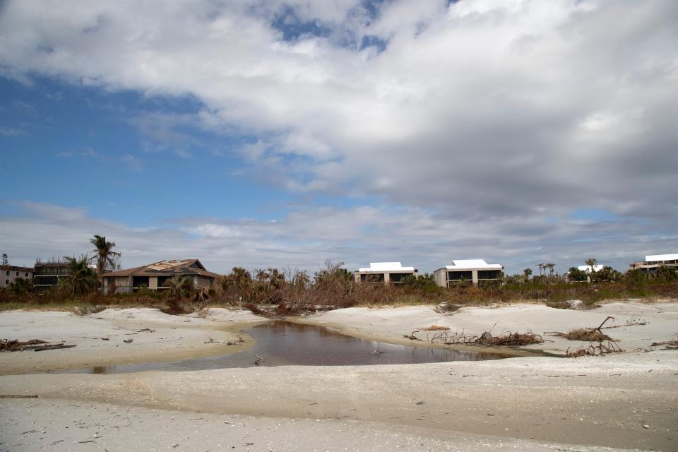 The beach on Sanibel has cuts of water left by the storm surge from Hurricane Ian.