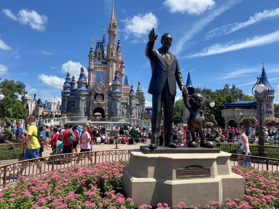 People gather at the Magic Kingdom theme park at Walt Disney World in Orlando, Florida.