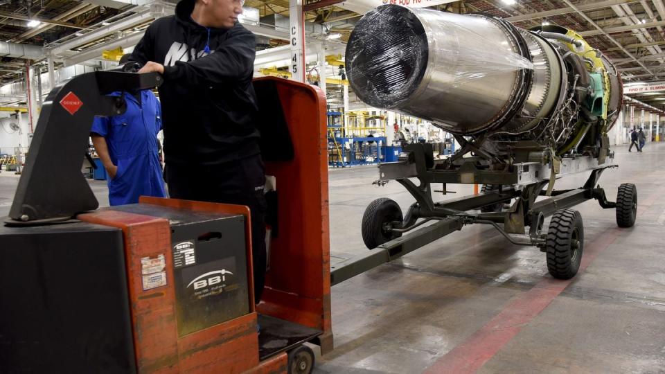 Fred Nanthakoummane, an engine mechanic with the 546th Propulsion Maintenance Squadron, moves a TF33 engine. (Kelly White/U.S. Air Force)