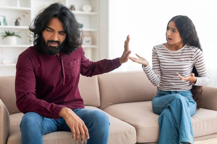 Two people having a heated conversation on a couch