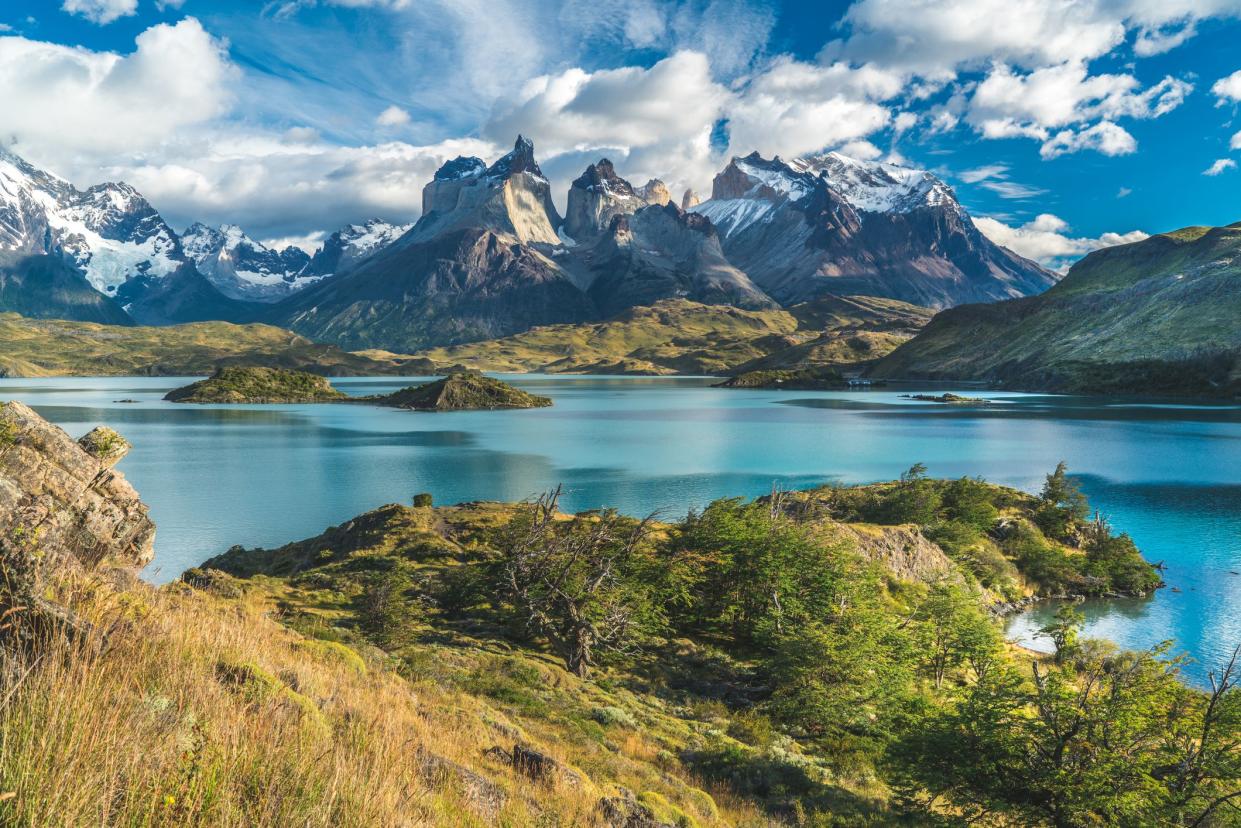 Blue lake Torres del Paine with snow mountain background and cloudy sky