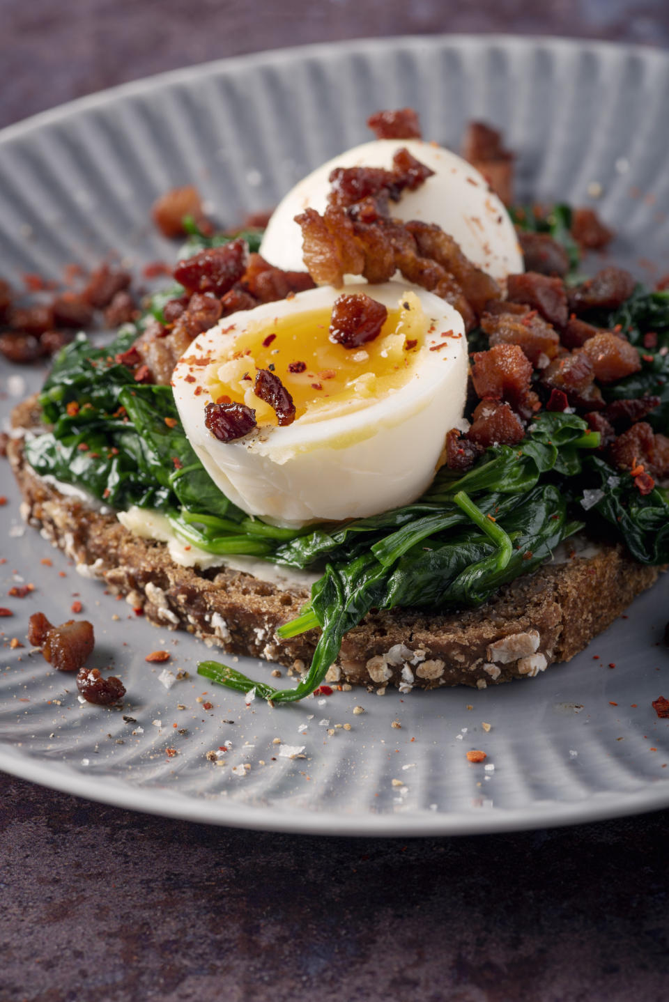 Soft boiled egg on toast with pancetta and spinach.