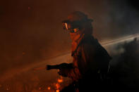 <p>A CalFire firefighter sprays water on a ridge as he battles the Loma Fire near Santa Cruz, California, U.S. September 27, 2016. (Stephen Lam/Reuters) </p>