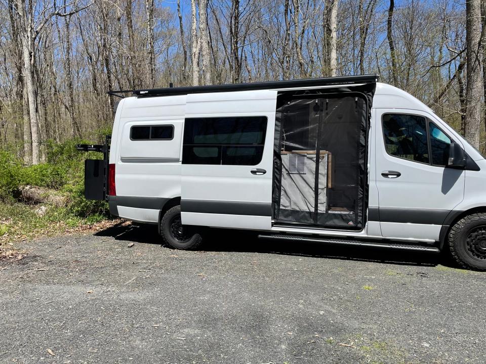 The sprinter with the door open but a netting covering it