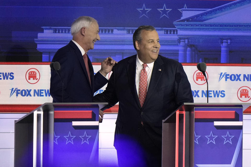 FILE - Former Arkansas Gov. Asa Hutchinson talks with former Arkansas Gov. Asa Hutchinson during break at a Republican presidential primary debate hosted by FOX News Channel, Aug. 23, 2023, in Milwaukee. (AP Photo/Morry Gash, File)