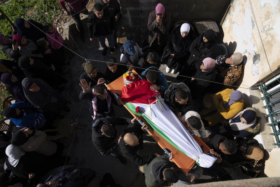 Mourners carry the body of Palestinian Abdel Rahman Hamed, 18, during his funeral in the West Bank town of Silwad, Monday, Jan. 29, 2024. Palestinian authorities say five Palestinians have been killed by Israeli forces in separate shootings across the occupied West Bank on Monday, including Hamed, who was killed during clashes with Israeli border police at his home village of Silwad. (AP Photo/Nasser Nasser)