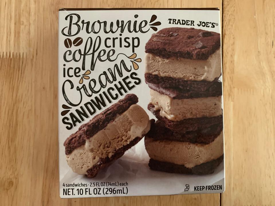 Brown and white box of Trader Joe's brownie crisp ice cream sandwiches on wood table
