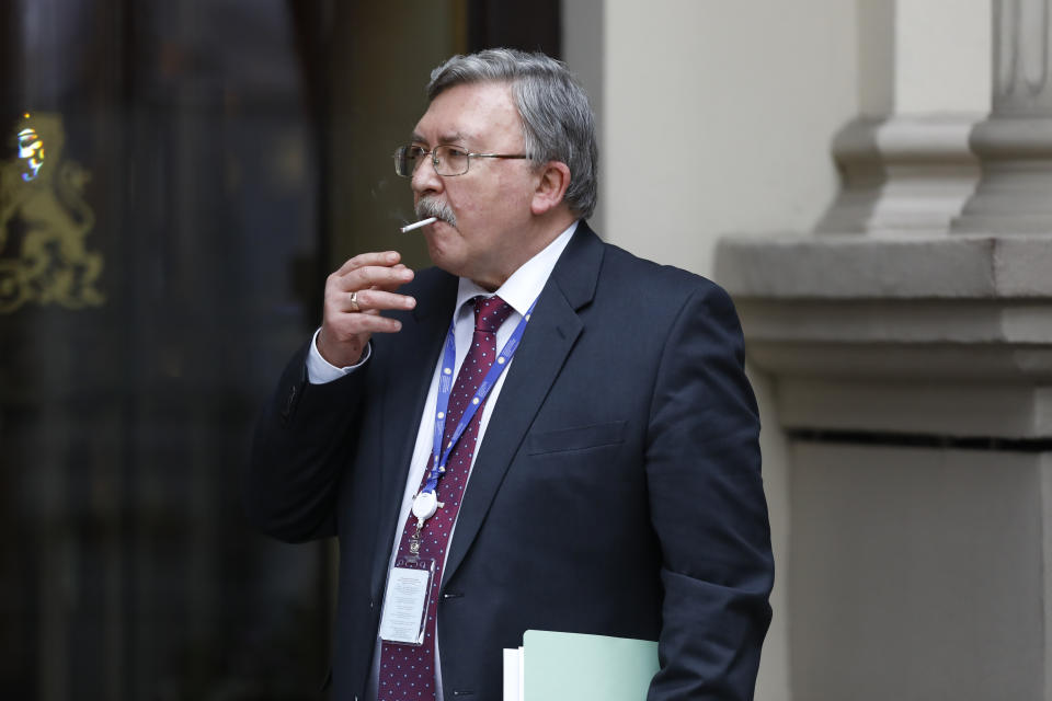 Russia's Governor to the International Atomic Energy Agency (IAEA), Mikhail Ulyanov, has a cigarette break in front of the 'Grand Hotel Wien' where closed-door nuclear talks with Iran were taking place in Vienna, Austria, Wednesday, May 19, 2021. World powers have held a fourth round of high-level talks aimed at bringing the United States back into a landmark nuclear deal with Iran. Both sides suggested a resolution was possible but major stumbling blocks remain. (AP Photo/Lisa Leutner)