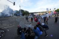 Demonstrators pull down a barricade during a protest against a recently approved mining contract between the government and Canadian mining company First Quantum, outside the National Assembly in Panama City, Monday, Oct. 23, 2023. (AP Photo/Arnulfo Franco)