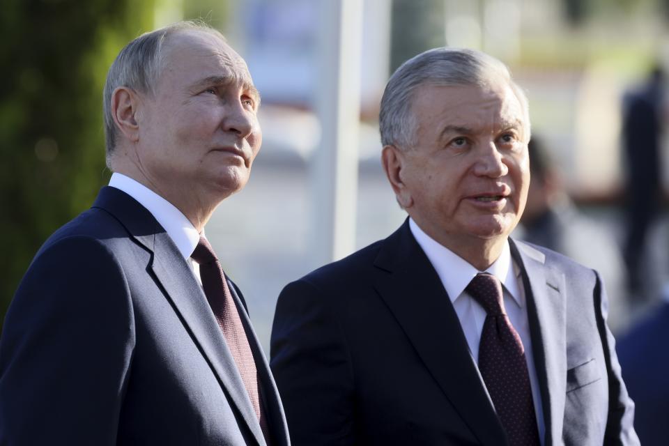 Russian President Vladimir Putin, left, and Uzbek President Shavkat Mirziyoyev stand after a flower laying ceremony at the Ode to Fortitude monument in the Victory Park memorial complex in Tashkent, Uzbekistan, Monday, May 27, 2024. (Mikhail Metzel, Sputnik, Kremlin Pool Photo via AP)