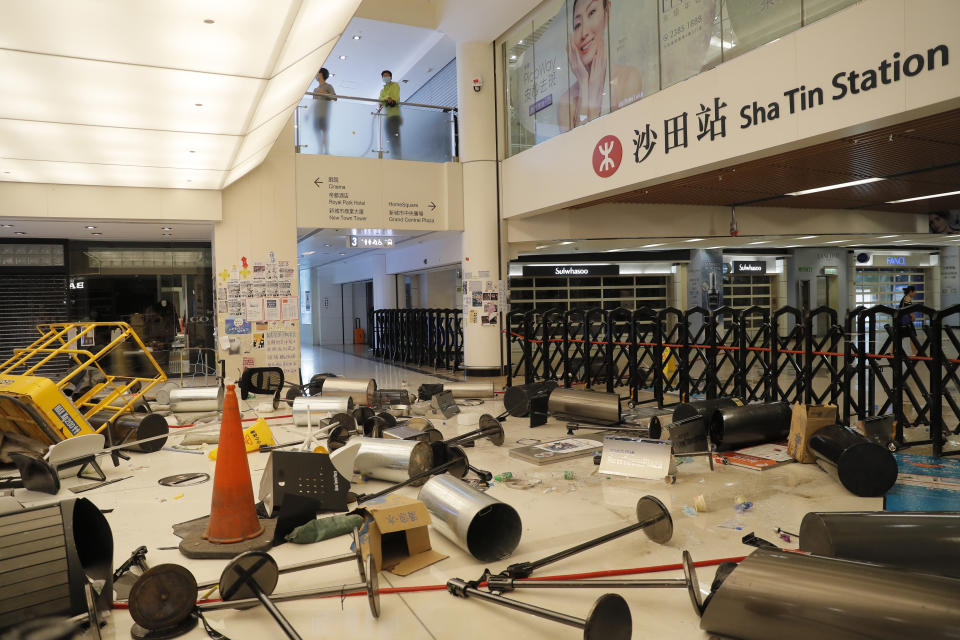 Protesters block the entrance to a subway station with debris Sunday, Sept. 22, 2019, in Hong Kong. Protesters smashed surveillance cameras and electronic ticket sensors in the subway station, as pro-democracy demonstrations took a violent turn once again. (AP Photo/Kin Cheung)