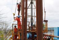 Workers labor at a facility of the petrochemical company Braskem in Maceio