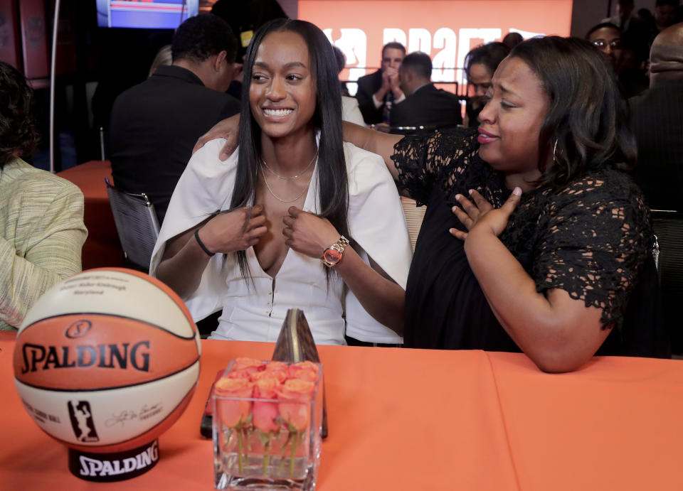 Shatori Walker-Kimbrough, left, reacts after being selected as the No. 6 pick in the WNBA basketball draft by the Washington Mystics, Thursday, April 13, 2017, in New York. (AP Photo/Julie Jacobson)