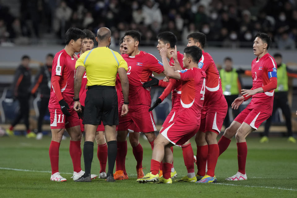 North Korea's players argue with referee during the FIFA World Cup 2026 and AFC Asian Cup 2027 preliminary joint qualification round 2 match between Japan and North Korea at the National Stadium Thursday, March 21, 2024, in Tokyo. (AP Photo/Eugene Hoshiko)