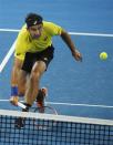 Marinko Matosevic of Australia dives for a return at the net to Roger Federer of Switzerland during their men's singles quarter-finals match at the Brisbane International tennis tournament in Brisbane, January 3, 2014. REUTERS/Jason Reed