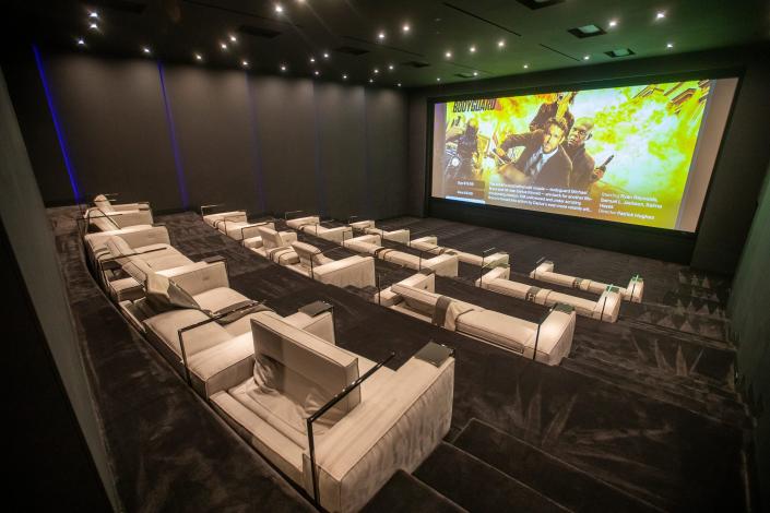 white seats in a home movie theater at mansion The One Bel Air