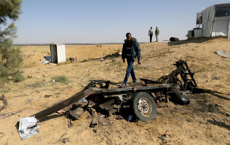 A Palestinian man looks at the scene of an explosion in the southern Gaza Strip, April 14, 2018. REUTERS/Ibraheem Abu Mustafa