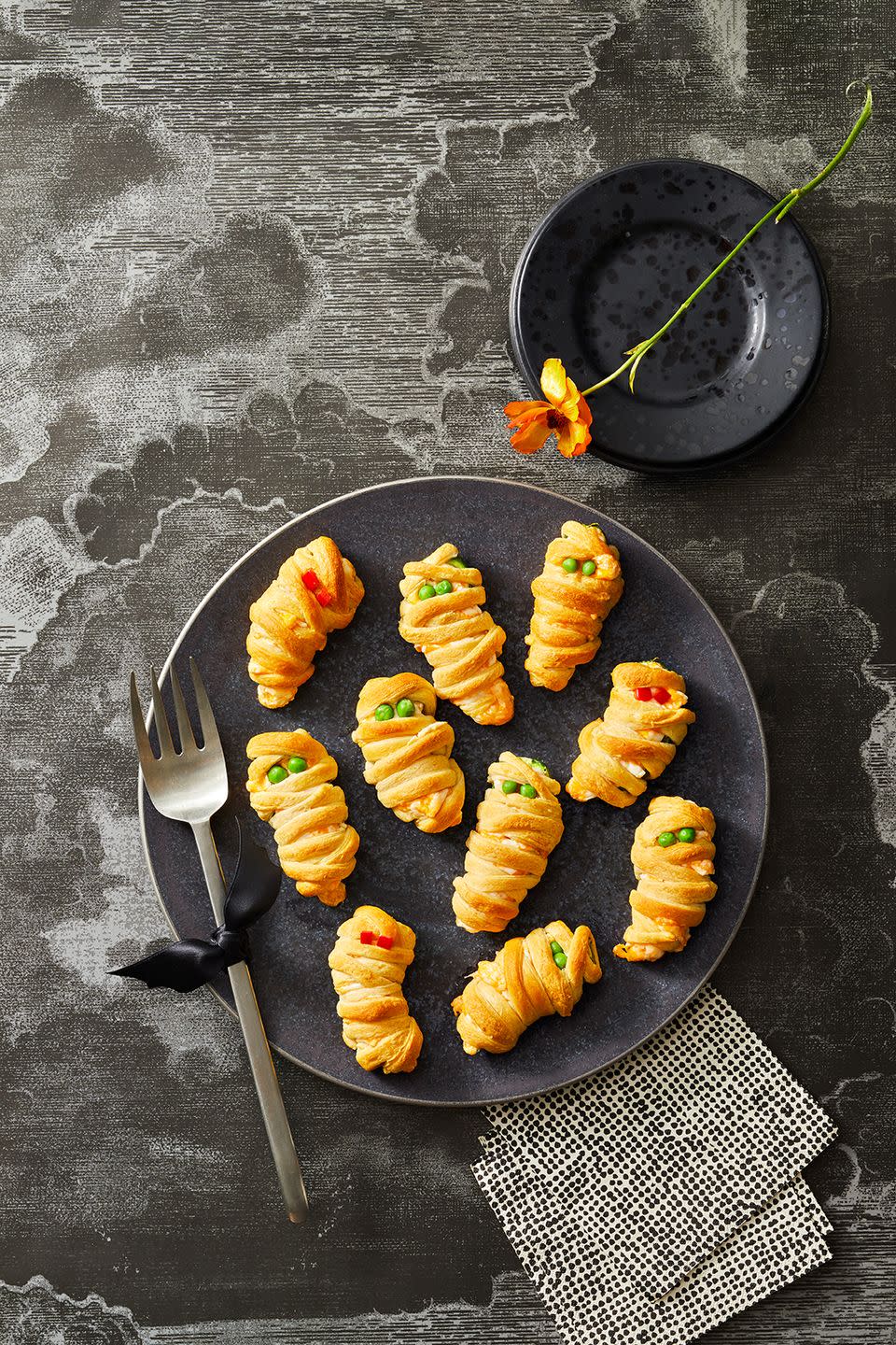 <p>Break out the crescent roll dough to make these cheesy and spicy apps for your Halloween party.<br><br>Get the <strong><a href="https://www.goodhousekeeping.com/food-recipes/party-ideas/a41535114/mummy-jalapeno-poppers-recipe/" rel="nofollow noopener" target="_blank" data-ylk="slk:Mummy Jalapeño Poppers recipe;elm:context_link;itc:0;sec:content-canvas" class="link ">Mummy Jalapeño Poppers recipe</a></strong>.</p>