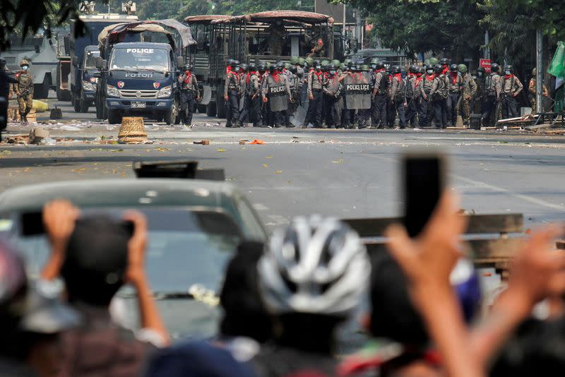 FILE PHOTO: FILE PHOTO: Police stand on a road during an anti-coup protest in Mandalay