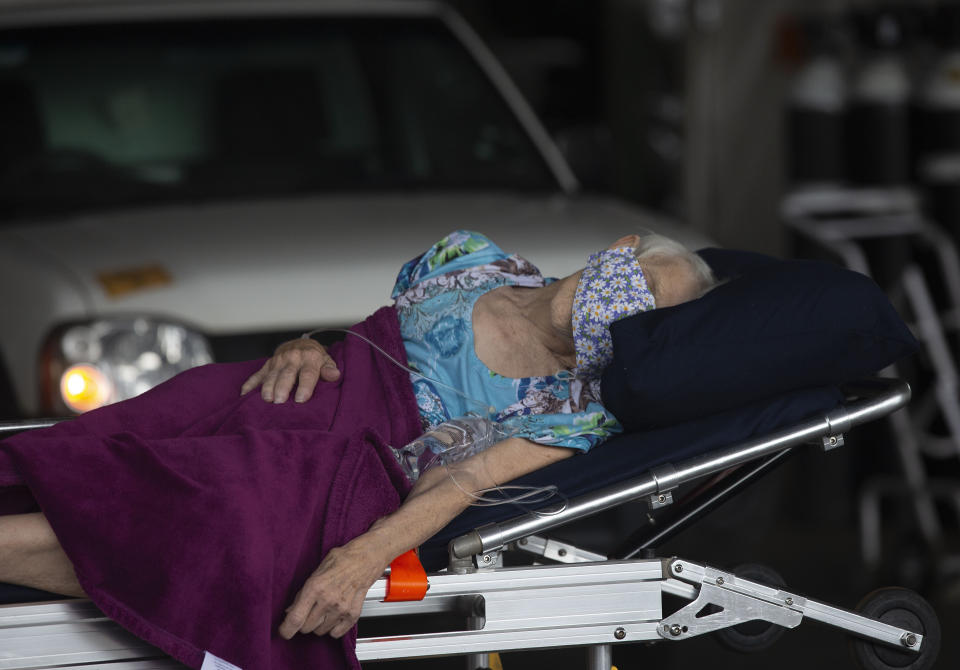 A patient arrives at the Steve Biko Academic Hospital's outside parking area in Pretoria, South Africa, Monday, Jan. 11, 2021. As the numbers of new confirmed cases rise, South Africa's hospitals are exceeding capacity, according to health officials. (AP Photo/Denis Farrell)