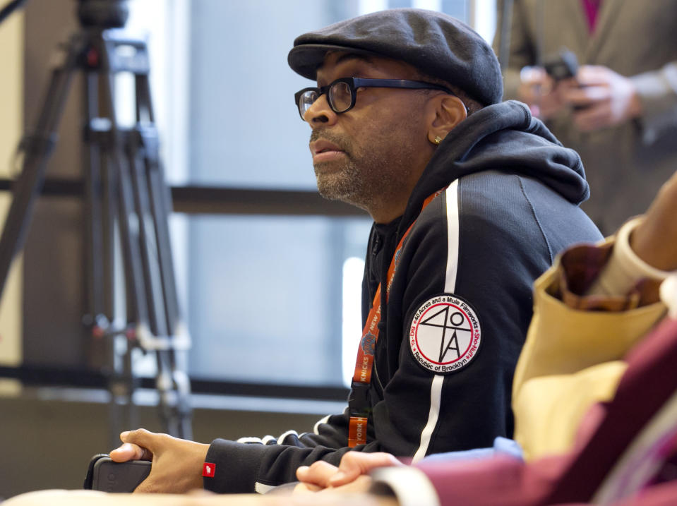 Filmmaker Spike Lee listens as New York Knicks new team president Phil Jackson addresses a news conference where he was introduced, at New York's Madison Square Garden, Tuesday, March 18, 2014. (AP Photo/Richard Drew)