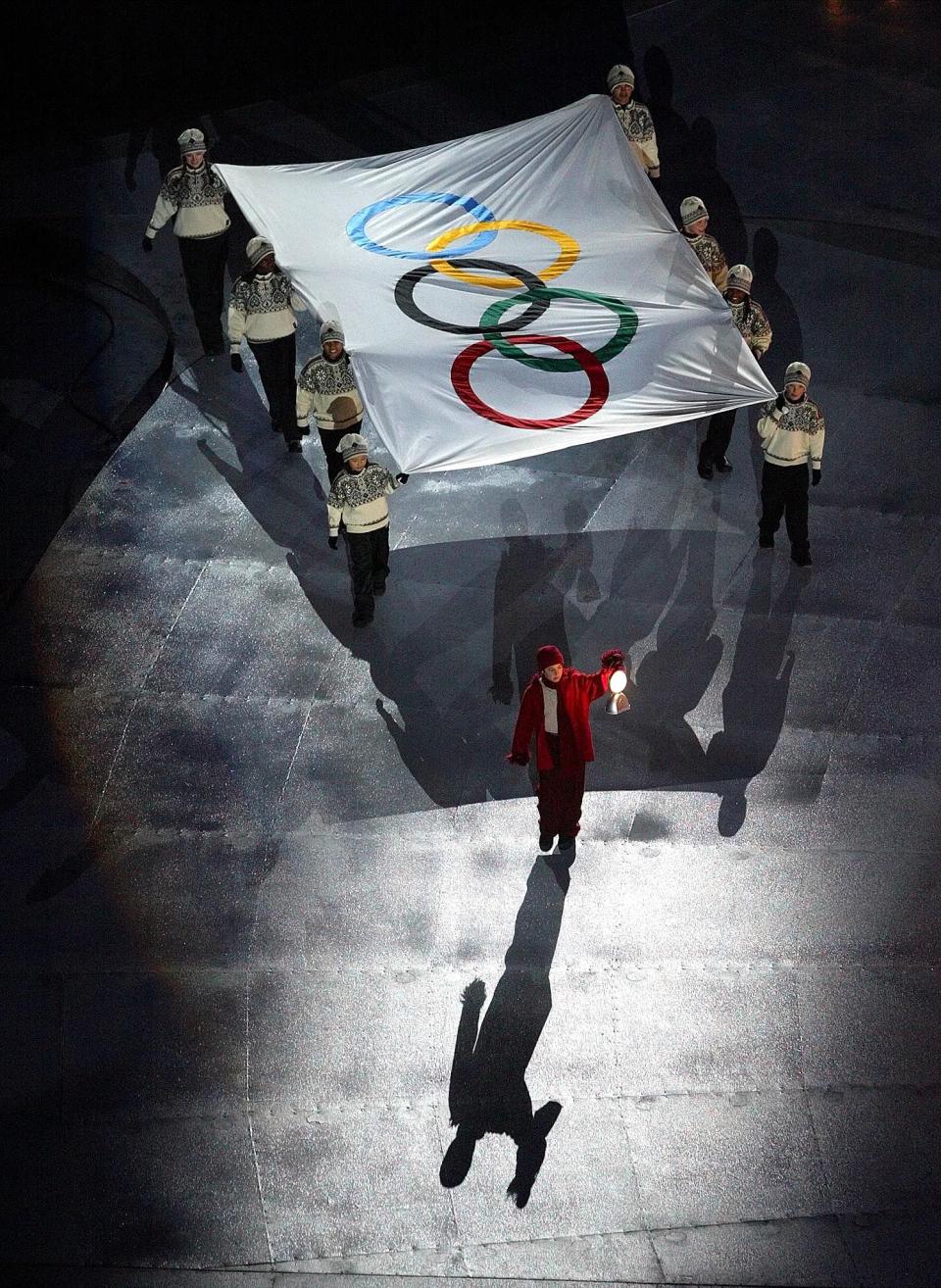 The Olympic flag is carried away during the Salt Lake 2002 Winter Games closing ceremony on Sunday, Feb 24, 2002, at the University of Utah’s Rice-Eccles Stadium in Salt Lake City. | Stuart Johnson, Deseret News