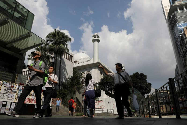 People walk past Kowloon Masjid and Islamic Centre in Hong Kong’s tourism district Tsim Sha Tsui