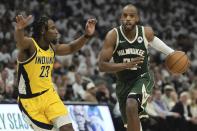 Milwaukee Bucks' Khris Middleton gets past Indiana Pacers' Aaron Nesmith during the first half of Game 2 of the NBA playoff basketball game Tuesday, April 23, 2024, in Milwaukee. (AP Photo/Morry Gash)