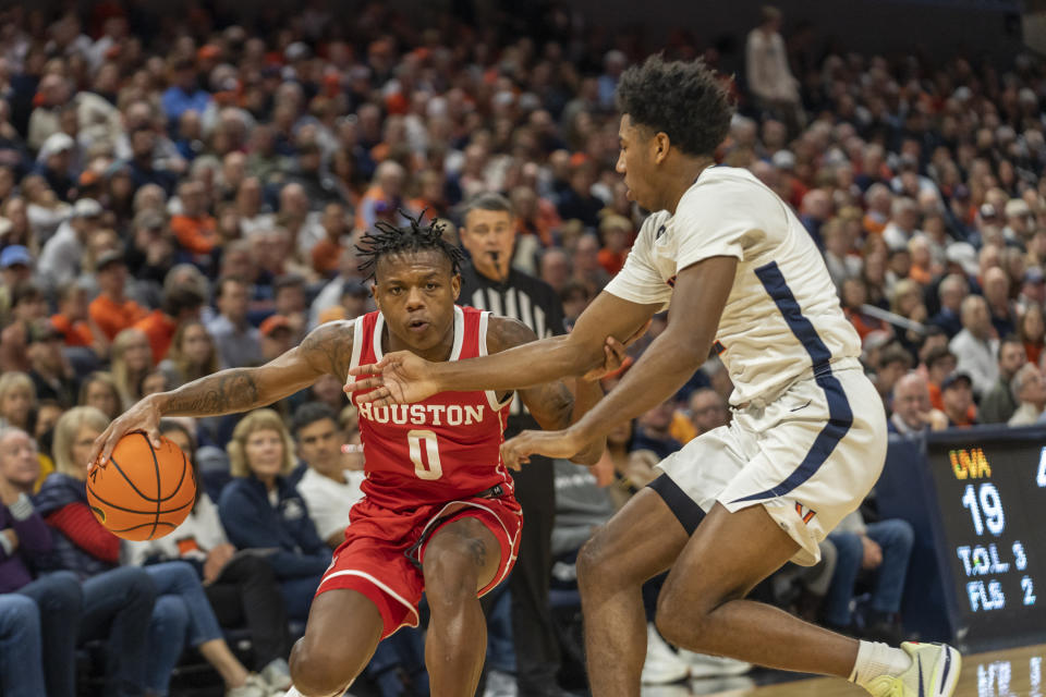 Houston guard Marcus Sasser (0) dribbles the ball during the first half of an NCAA college basketball game against Virginia in Charlottesville, Va., Saturday, Dec. 17, 2022. (AP Photo/Erin Edgerton)