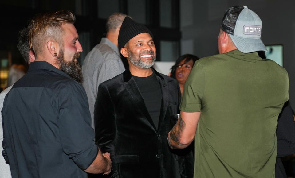 Mike Epps, center, talks to Anthony Godfrey, left, during a special screening of the HGTV series “Buying Back the Block” at The Living Room Theaters at the Garage in Indianapolis on Nov. 8, 2023.