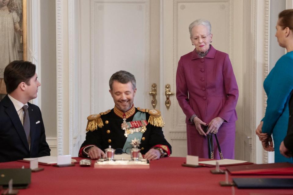 After signing the declaration of abdication Queen Margrethe II of Denmark, second right, leaves the seat at the head of the table to her son King Frederik X of Denmark (Getty)