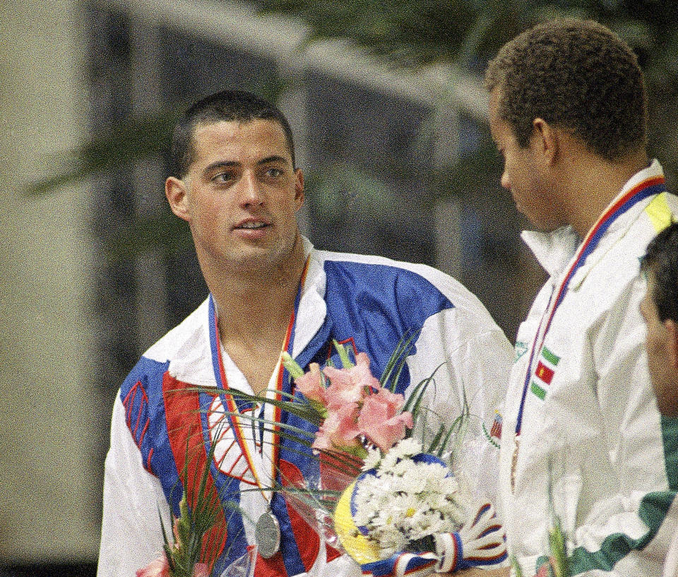 FILE - Silver medalist Matthew Bondi, left, of the United States, talks with gold medalist Anthony Nesty, right, of Suriname, on the winners stand after the men's 100-meter butterfly finals in Seoul, Sept. 21, 1988. In a sport still struggling to diversify, Nesty is a significant presence on the pool deck at the U.S. national championships. (AP Photo/Mark Duncan, File)