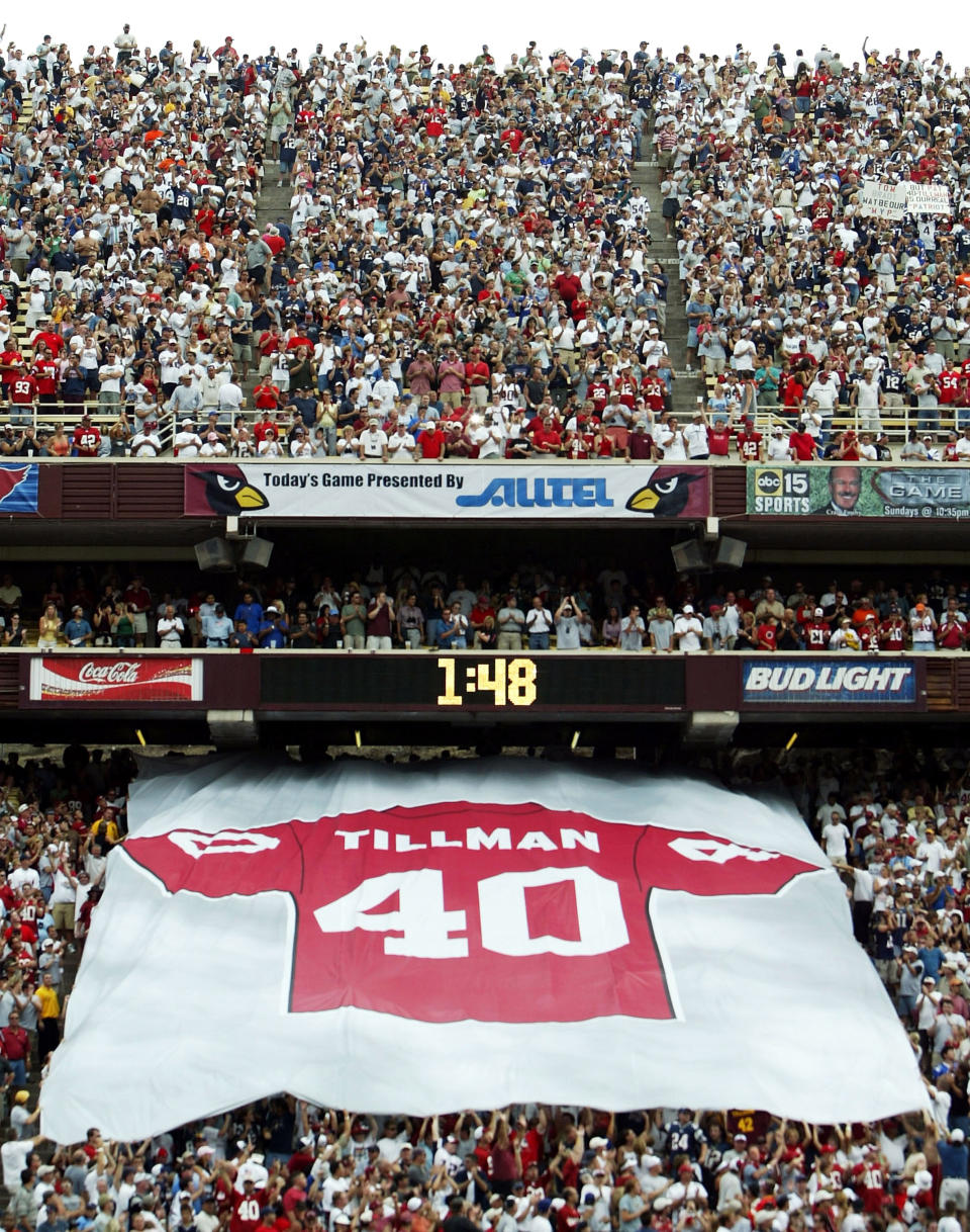 A giant #40 jersey is passed down by fans in a half time ceremony honoring the late Pat Tillman, who was killed in military action in Afganistan, during a game between the New England Patriots and the Arizona Cardinals at Sun Devil Stadium on September 19, 2004 in Tempe, Arizona. (Photo by Jeff Gross/Getty Images)