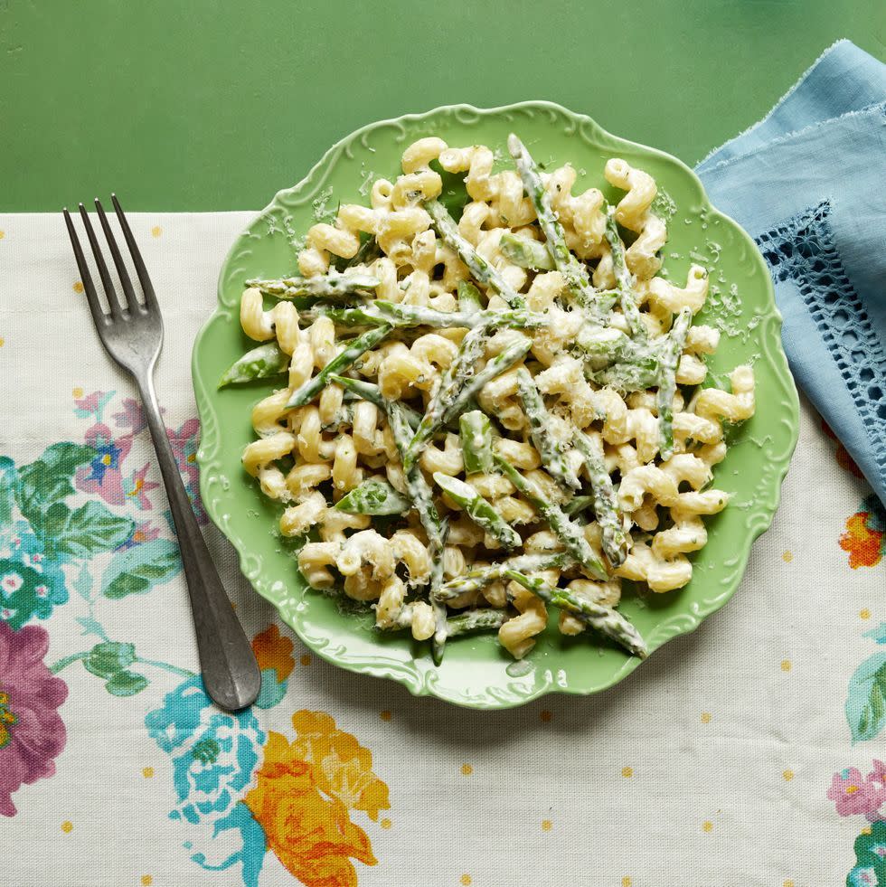 creamy pasta primavera on green plate