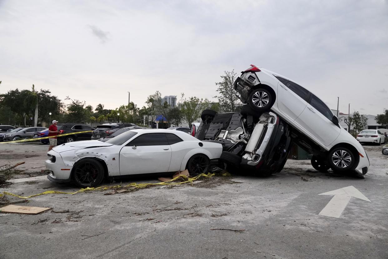 Damaged cars appear in a parking lot after a reported tornado hit the area Sunday, April 30, 2023 in Palm Beach Gardens, Fla. (Joe Cavaretta/South Florida Sun-Sentinel via AP)