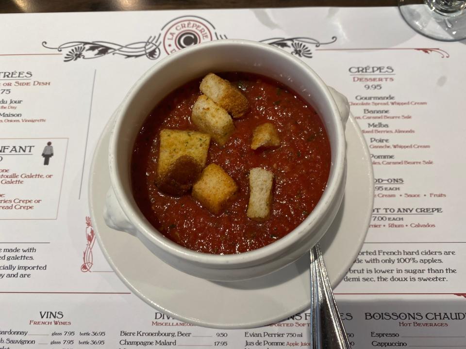 tomato soup with croutons in white bowl at le creperie de paris at epcot