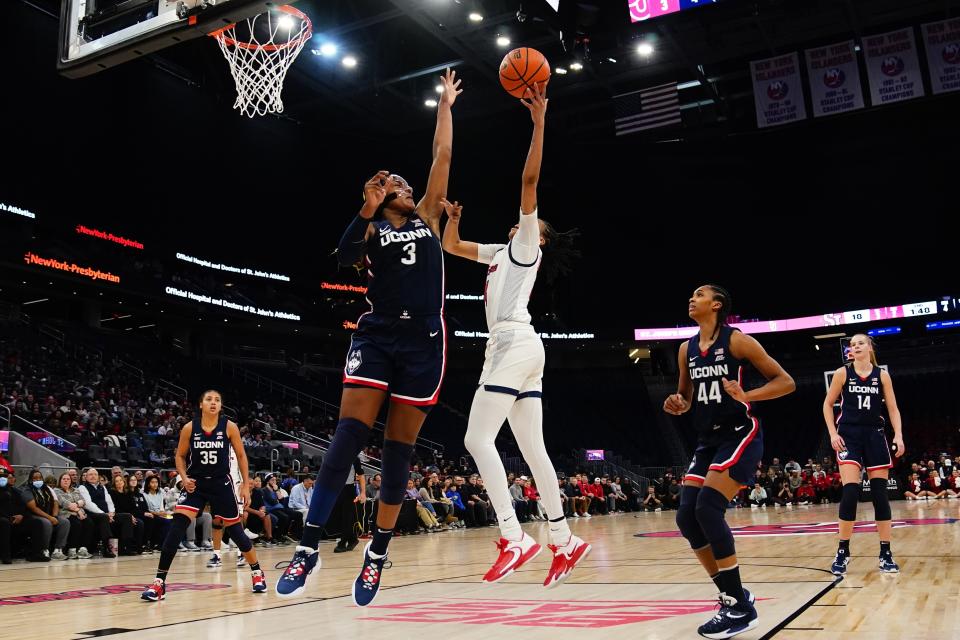 Connecticut's Aaliyah Edwards (3) defends a shot by St. John's Jayla Everett (4) during the first half of an NCAA basetball game Wednesday, Jan. 11, 2023, in New York. (AP Photo/Frank Franklin II)