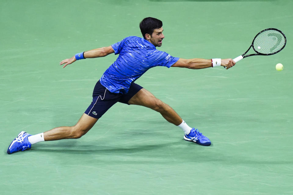 Novak Djokovic, of Serbia, returns to Stan Wawrinka, of Switzerland, during round four of the U.S. Open tennis championships Sunday, Sept. 1, 2019, in New York. (AP Photo/Eduardo Munoz Alvarez)