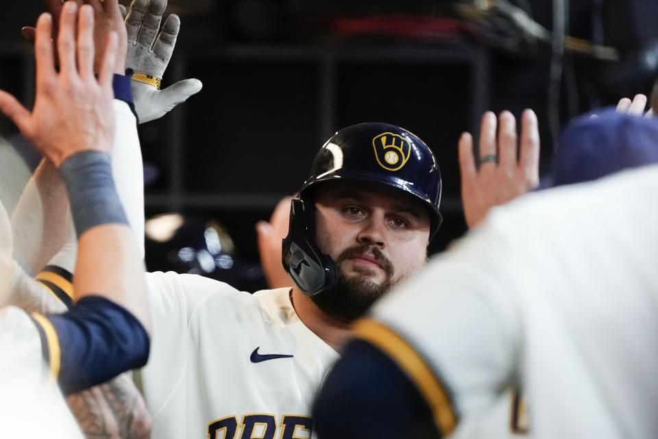 Milwaukee Brewers' Rowdy Tellez is congratulated after hitting a two-run home run during the sixth inning of a baseball game against the Cincinnati Reds Wednesday, May 4, 2022, in Milwaukee. (AP Photo/Morry Gash)