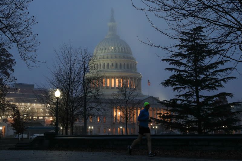 A man runs past the U.S. Capitol dome early in the morning on Capitol Hill in Washington