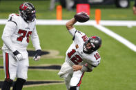 Tampa Bay Buccaneers quarterback Tom Brady (12) celebrates his touchdown with offensive tackle Donovan Smith (76) in the first half of an NFL football game against the New Orleans Saints in New Orleans, Sunday, Sept. 13, 2020. (AP Photo/Brett Duke)