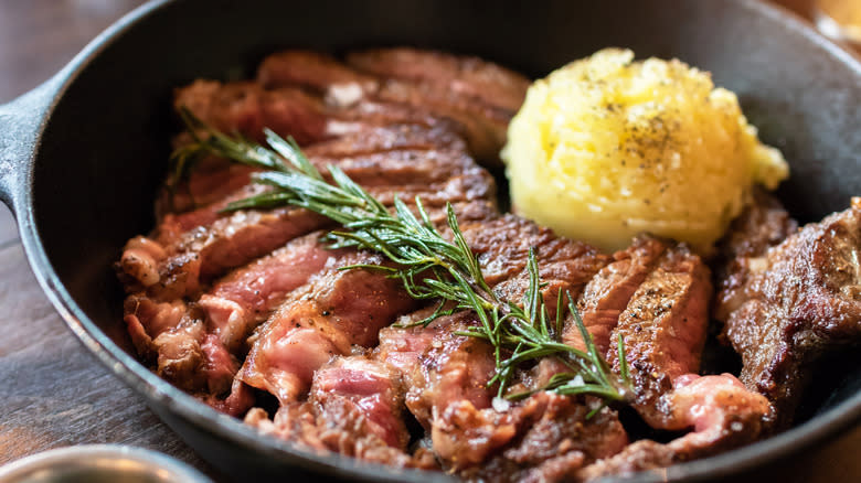 Steak, mashed potatoes, rosemary, in cast iron