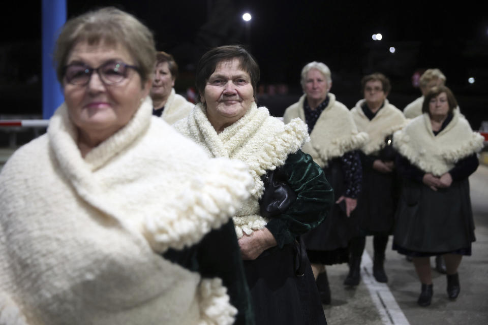 Women in traditional Croatian clothing arrive at the border crossing in Gorican, Croatia, Sunday, Jan. 1, 2023. More than nine years after Croatia became the European Union's newest member, it is switching to the EU's common currency, the euro, and joining Europe's passport-free travel Schengen area. (AP Photo/Armin Durgut)