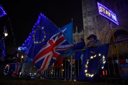 Anti-Brexit demonstrators stand outside the Houses of Parliament in London