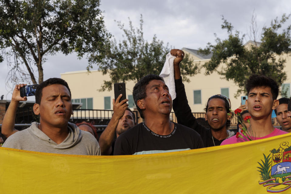 Migrants sing the Venezuelan national anthem during a vigil for the eight migrants that were killed and several others that were injured the day before while waiting at a bus stop, in Brownsville, Texas, Monday, May 8, 2023. (AP Photo/Michael Gonzalez)