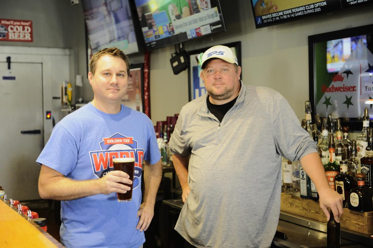 Jason Elliot, left, and Cory Edwards stand behind the bar at Neighbors on Monday, Nov. 6, 2023.